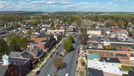 Quaint-USA-town-square-with-American-flag-waving-during-spring-afternoon