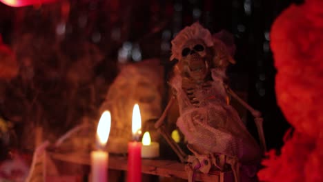 Candles-and-skeletons-on-the-altar,-Day-of-the-Dead-ofrenda