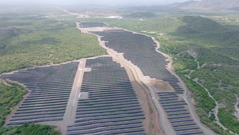 Aerial-birds-eye-shot-of-large-solar-panel-power-station-on-tropical-island