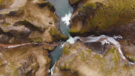 Eroded-cliffs-and-whitewater-river-rapids-in-Fjadrargljufur-canyon