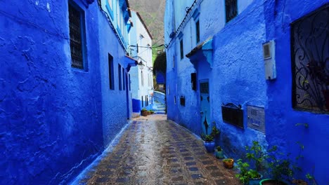 Walking-POV-street-in-Chefchaouen,-Morocco-blue-facade-buildings-North-Africa