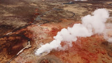 Aerial-shot-of-steam-rising-from-colorful-Gunnuhver-hot-springs-in-Iceland