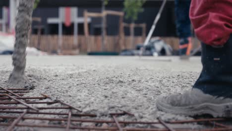 Construction-worker-pouring-cement-or-concrete-with-pump-tube