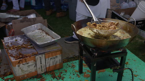 Deep-fried-vegetable-pakora-is-scooped-into-pan-at-Nagar-Kirtan-fest