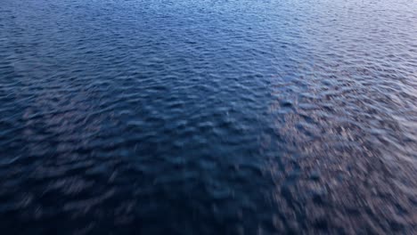 Deep-dark-blue-ocean-water-textured-natural-background,-aerial