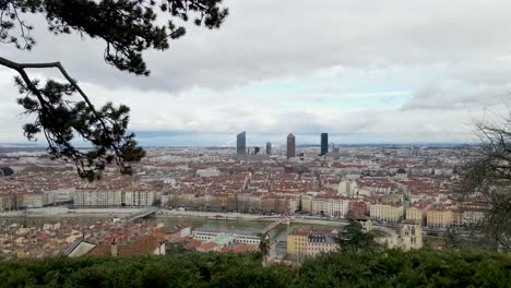 reveal-shot-of-Lyon-city-red-roof-tops-and-tall-buildings-during-a-cloudy-day