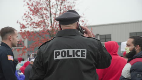 The-back-of-a-police-office-watching-over-the-entrance-to-a-Trump-Rally-in-the-lead-up-to-the-2020-election