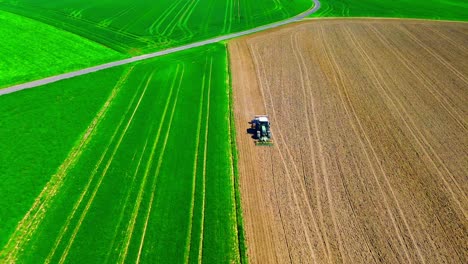 Vibrant-Contrast-of-Fresh-Green-and-Plowed-Brown-Fields-from-Above