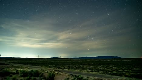 Starry-night-along-a-desert-road-in-the-countryside---time-lapse