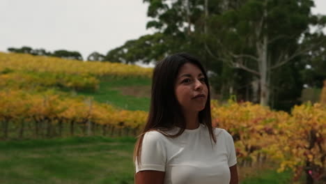 Cinematic-Orbit-of-Woman-in-Vineyard-Autumn