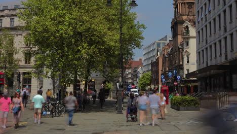 Timelapse-of-pedestians-walking-near-St-Martin's-Lane,-London-on-a-hot,-sunny-lunchtime