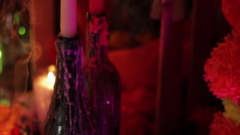 Dripping-candles-and-incense-smoke-on-Day-of-the-Dead-altar,-offerings