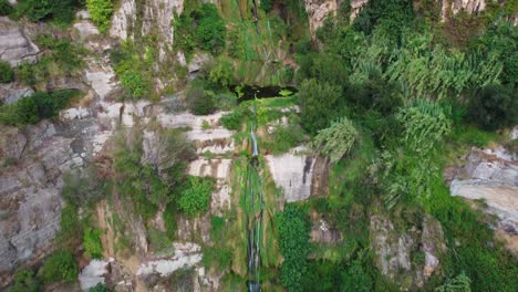 Sant-miquel-del-fai-with-lush-greenery-and-a-waterfall-in-barcelona,-aerial-view