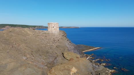 Travel-Coast-Landscape-in-Torre-d'Es-Colomer-Stone-Old-Tower,-Blue-Sea,-Skyline-Aerial-Drone-Panoramic