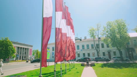 Latvian-red-white-colored-flag-banners-in-wind-during-spring-in-Baltic-country-Latvia