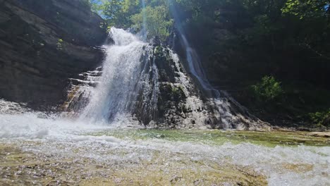 Experience-the-serene-beauty-of-a-cascading-waterfall-captured-by-a-stationary-camera