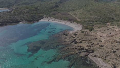 Coastline-of-Cala-Sa-Torreta-Menorca-Spain-Blue-Beach-Coastline-Aerial-Drone-Travel-Shot