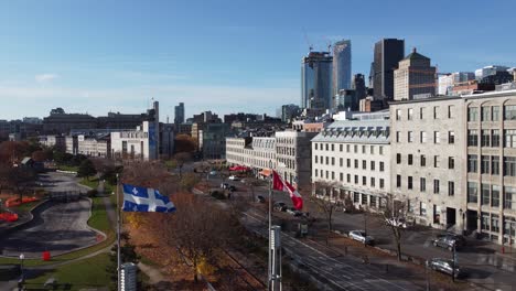 aerial-of-Old-Port-of-Montreal-district-with-traffic-car-and-Canadian-flag