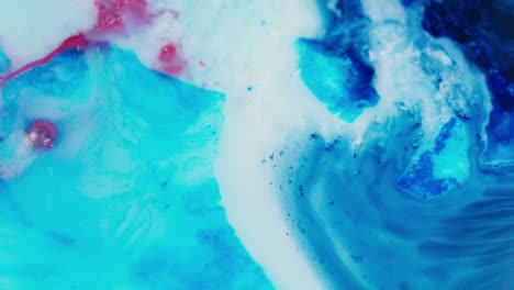 Vibrant-blue-and-red-ink-swirling-in-water-creating-a-mesmerizing-abstract-pattern