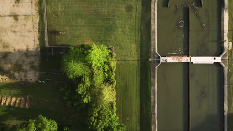 The-collierville-wastewater-treatment-plant-in-tennessee-by-a-green-landscape,-aerial-view