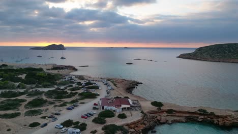 cala-comte-beach-with-boats,-stunning-ibiza-sunset-sky