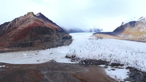 Massive-Eisdecke-Mit-Rissen-Zwischen-Den-Berggipfeln-Im-Nebel,-Island