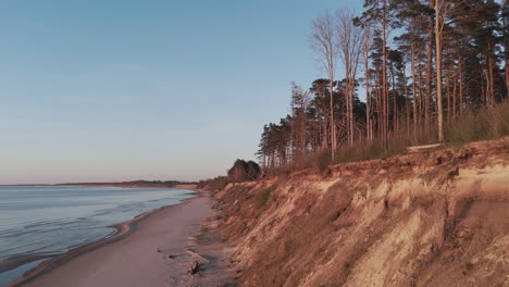 Establishing-Aerial-Shot-of-Coastline-Baltic-Sea-Jurkalne-on-Evening-at-Sunset