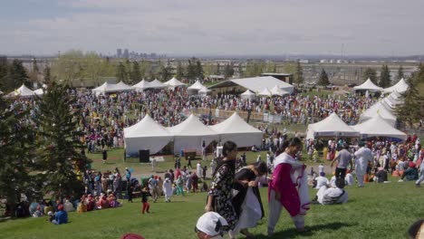 Pan-across-city-park-crowd,-Nagar-Kirtan-Sikh-spring-harvest-festival