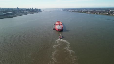 Colourful-massive-oil-tanker-sailing-up-River-Mersey---aerial-drone-move-in-and-flyover,-England,-UK