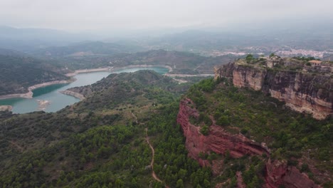 Siurana-town-and-river-in-tarragona-with-surrounding-lush-landscapes-and-cliffs,-aerial-view