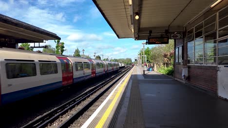 1973-Stock-Piccadilly-Line-Train-Arriving-At-Rayners-Lane-Station-Platform-On-Sunny-Day