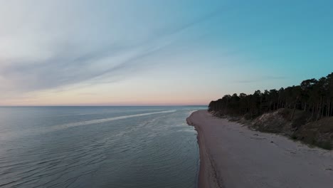 Aerial-Birdseye-View-of-Baltic-Sea-Coast-on-a-Sunny-Day,-Seashore-Dunes-Damaged-by-Waves,-Broken-Pine-Trees,-Coastal-Erosion,-Climate-Changes,-Wide-Angle-Drone-Shot