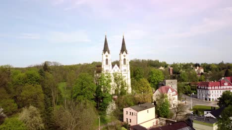 Aerial-view-of-the-Church-of-the-Nativity-of-the-Virgin-Mary-in-Orlova,-Czech-Republic---pullback-shot