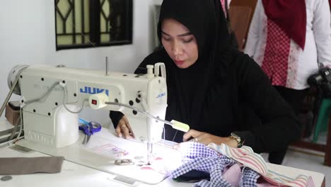 A-mother-is-sewing-clothes-in-a-place,-Batang-Indonesia-May-13-2024
