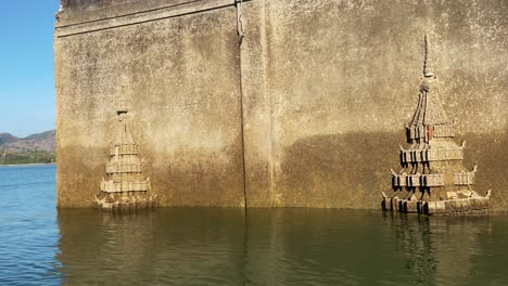 The-ruins-of-the-ancient-Buddhist-temple-Wat-Saam-Prasob,-half-submerged-in-the-waters-of-Lake-Khao-Laem-in-Sangkhlaburi,-Thailand