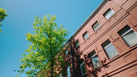 Sunlight-reflecting-in-windows-of-neoclassical-red-brickstone-building-in-Central-Europe