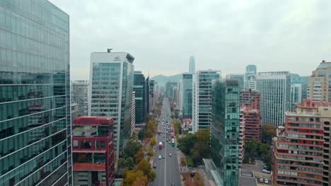 Aerial-drone-fly-slow,-Santiago-de-Chile-High-Glass-mirrored-skyscrapers,-modern-architecture-of-South-american-Capital,-Apoquindo-avenue