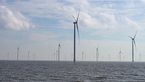 Windturbine-field,-panning-shot,-in-Lake-IJssel-of-the-Netherlands,-Europe