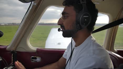 Profile-View-of-Male-Private-Pilot-in-Airplane-Taxiing-at-the-Airport