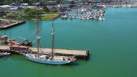 Aerial-view-around-a-tallship,-docked-at-the-Sausalito-marina,-in-California,-USA