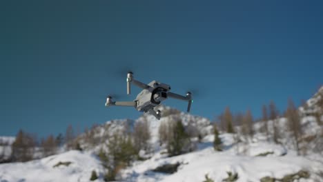 Advanced-professional-DJI-Air-2S-drone-flying-with-snow-on-mountains-in-background