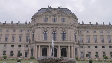 Tilt-up-shot-of-the-ornate-facade-of-a-historic-building-in-Bamberg,-featuring-a-fountain