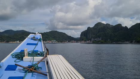 Boat-Sailing-To-El-Nido-Town-and-Port-on-Cloudy-Day-POV,-Palawan,-Philippines