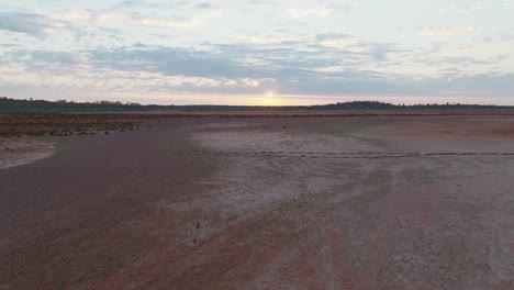 Drone-clip-showing-two-sets-of-footprints-through-remote-Australian-outback-and-male-model