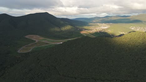 Aerial-Push-Over-Salta,-Argentina's-Autódromo-Martín-Miguel-de-Güemes-Ractrack-And-Forested-Mountains