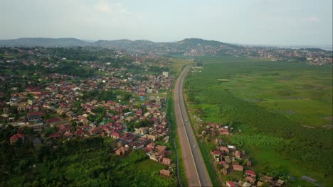 Residential-Area-Close-to-the-Kampala-Entebbe-Expressway-in-Uganda,-East-Africa---Drone-Flying-Forward