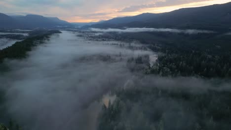 Aerial-view-of-Secluded-Scenic-Lake-and-Foggy-Trees-at-Sunrise