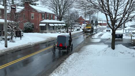 Amish-horse-and-buggy-passing-through-small-town-in-rural-USA