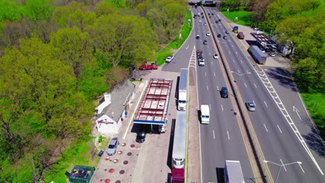 Aerial-shot-of-a-gas-station-on-I-87-in-Bronx,-NY,-busy-with-vehicles-and-services