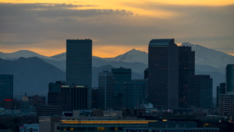 Cherry-Creek-buildings-on-skyline-lighting-up-at-twilight,-Denver-timelapse